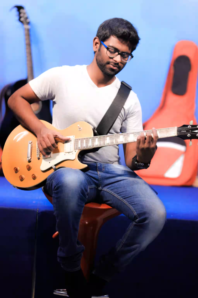 Student playing an electric guitar